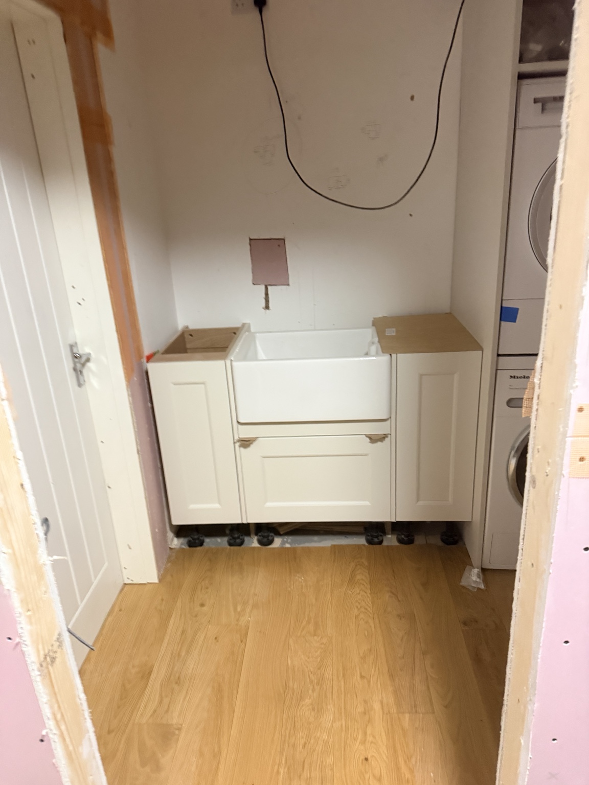 Utility room base cabinets at the start of installation